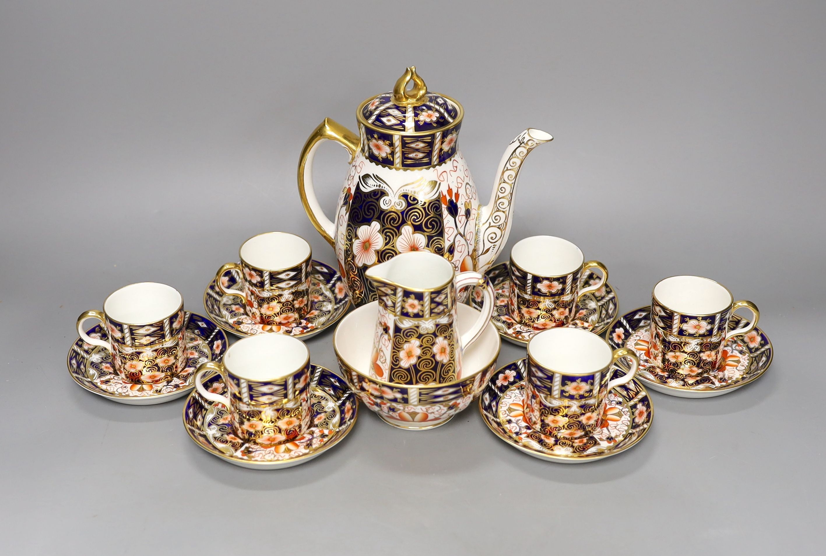 A Royal Crown Derby Imari pattern 2451 coffee set, comprising coffee pot, bowl jug and six cups and saucers.